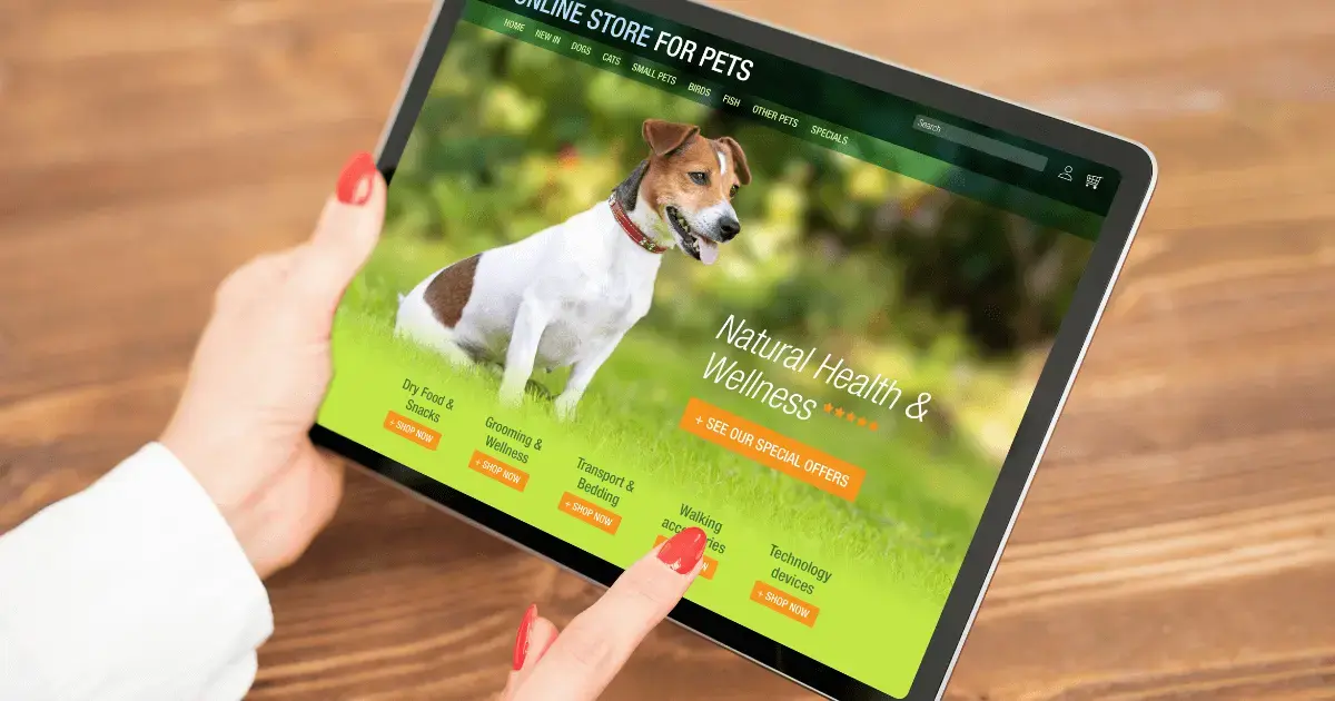 A digital marketing specialist analyzing a campaign for a pet brand on a tablet.